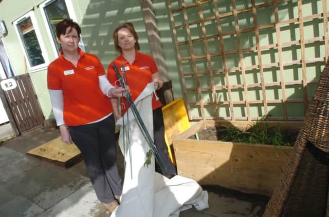 Childcare suffered vandalism at the weekend, manager Fiona Greatorex with supervisor Rachel Turner and the damaged canopy.