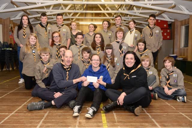 Explorer Scouts receiving cheque after hut vandalised, scout hut, Station road, Toddington
