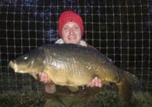 Josh Hammersley with his mirror carp known as Pecs