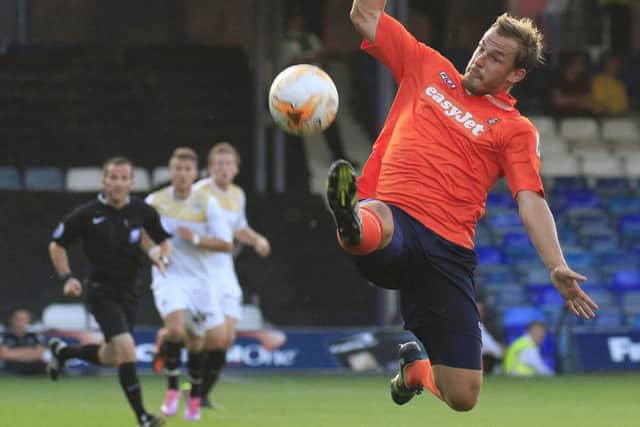 Luke Wilkinson makes an acrobatic clearance for Luton v Colchester. Liam Smith. PNL-140730-085822002