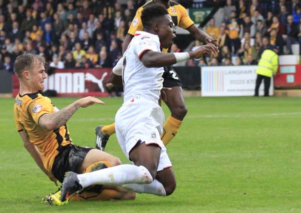 Pelly Ruddock Mpanzu is fouled for Town's penalty at Cambridge