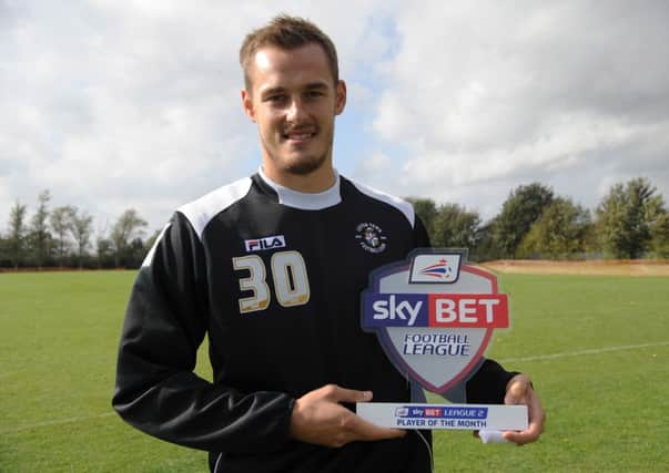 Luke Wilkinson with his player of the month award