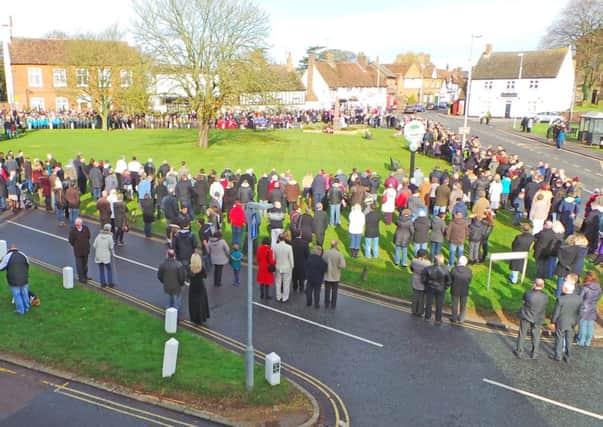 Crowds gather around Toddington village green