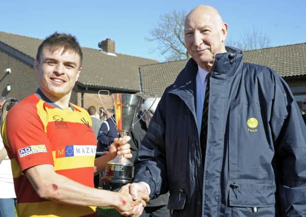 Stockwood Park's Jamie Hoque lifts the trophy