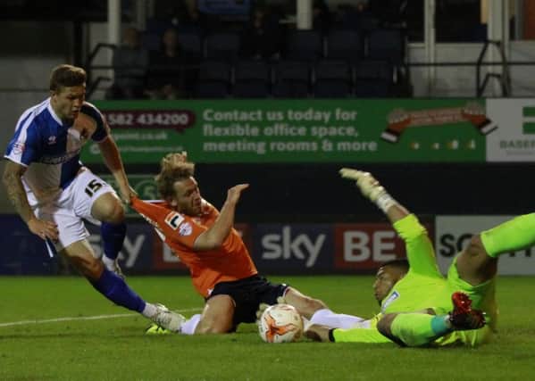 Craig Mackail-Smith is beaten to the ball by visiting keeper Aaron Chapman