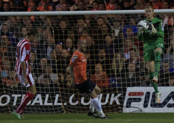 Scott Cuthbert sees Elliot Justham beat Peter Crouch to the ball