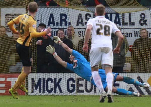 Mark Tyler saves from the spot against Cambridge last season only for the rebound to be scored