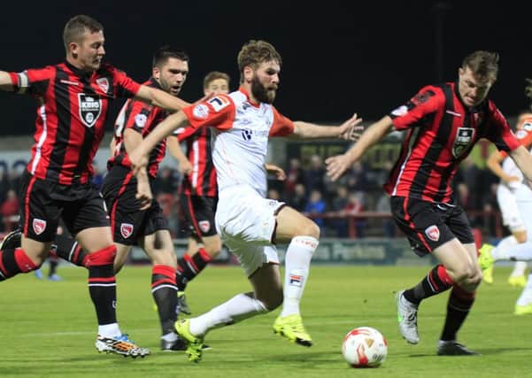 Paddy McCourt takes on the Morecambe defence