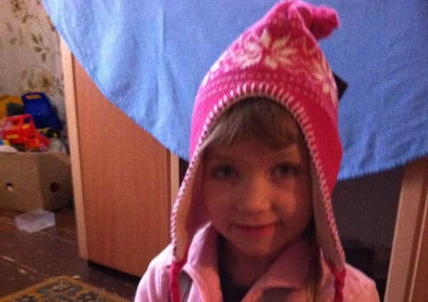 Happiness is a cosy hat - little Leeza in Belarus with one of thegifts from Operation Christmas Child