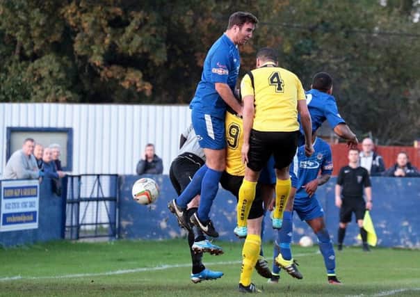 Paul Andrews leaps during Barton's defeat to AFC Rushden