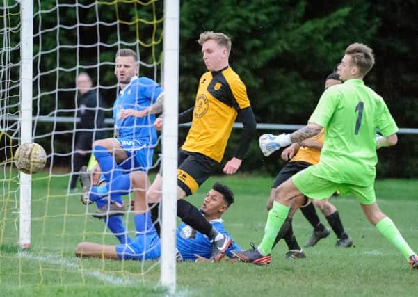 Josh Humbert slides in to score for AFC Dunstable at Stotfold