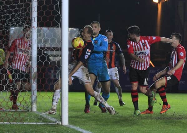 Paul Benson bundles the ball over the line in the last minute