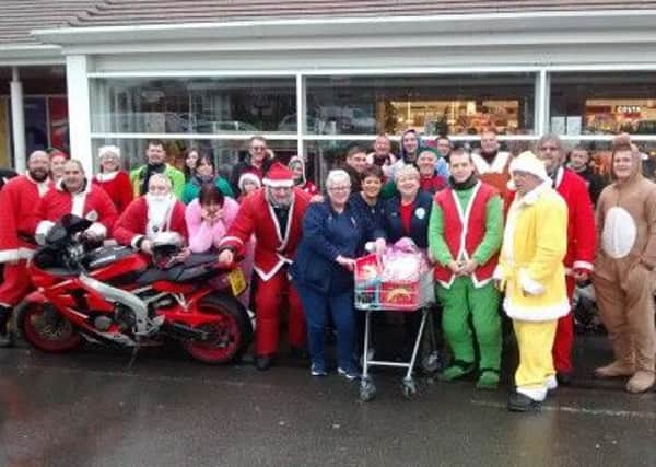 The bikers and some Tesco staff outside the store