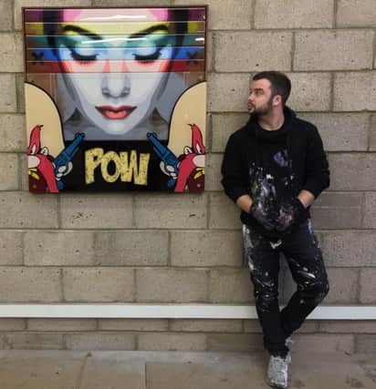Pop artist Lhouette - Ciaran Robinson - with one of his works