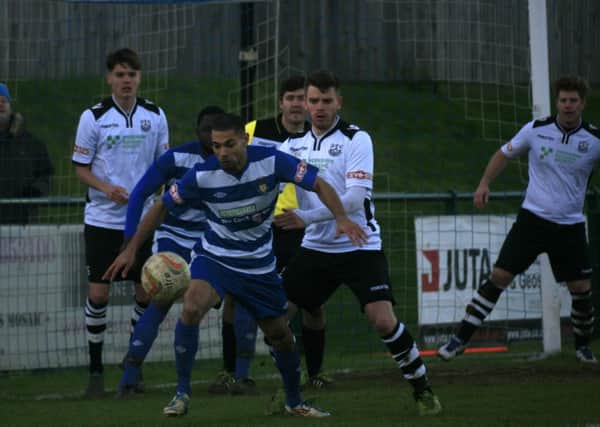 Lee Roache shields the ball against Cambridge City on Saturday