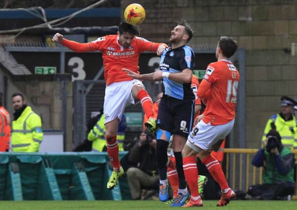 Alan Sheehan heads clear against Wycombe