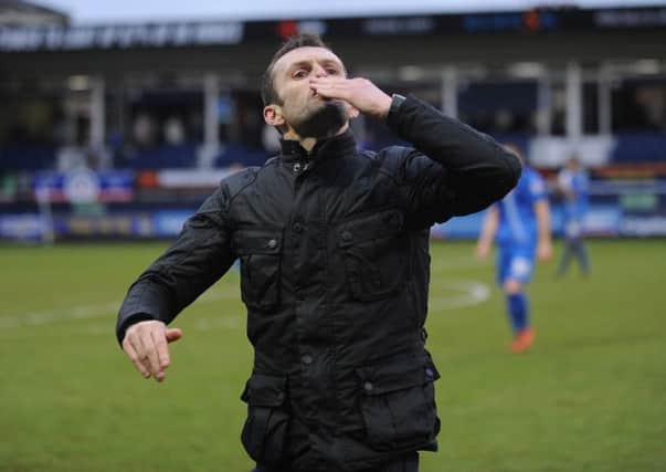 Sealed with a kiss: Nathan Jones celebrates his first home victory