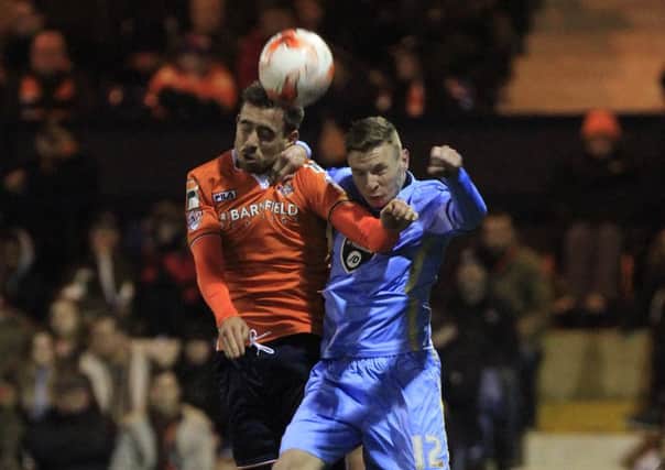 Olly Lee challenges for the ball against Morecambe