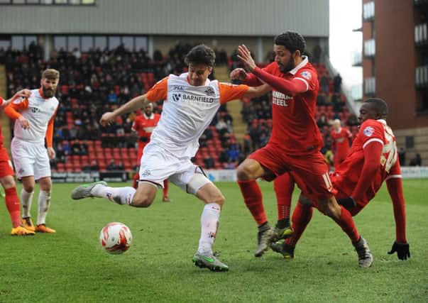 Jonathan Smith gets stuck in against Orient