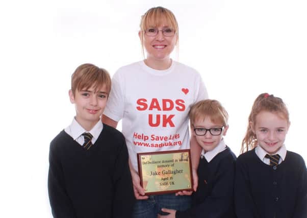 Dunstable mum Sarah Pyatt and her family with the plaque in memory of her son Jake