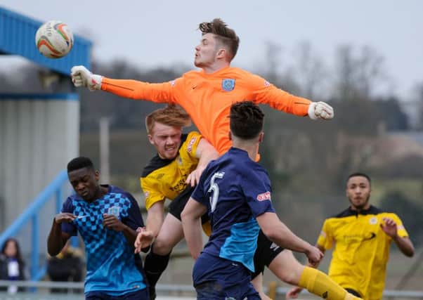 Arlesey keeper Nick Thompson punches clear against Barton on Saturday