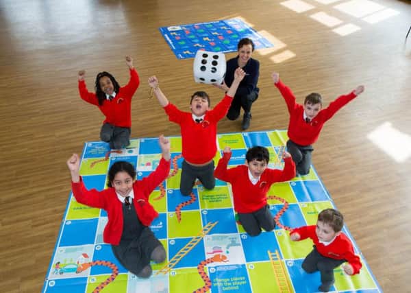 Water saving lesson at Bushmead School - pupils play water saving snake and ladders with Affinity Water Education Cordinator, Melissa Painter.