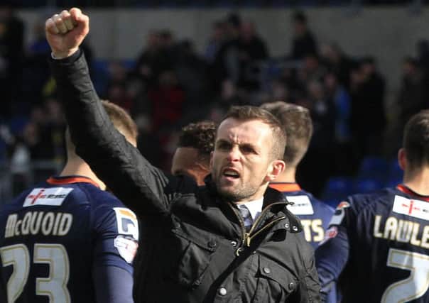 Nathan Jones punches the air after victory over Oxford United