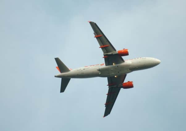 An easyJet plane flying over Luton