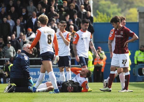 Danny Green receives treatment after a suspected leg break at Northampton