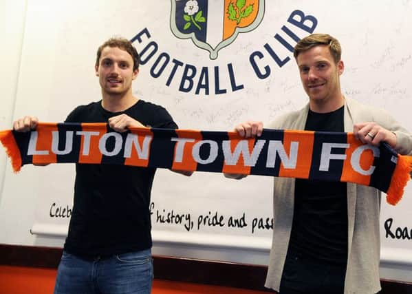 Oxford duo Danny Hylton and Johnny Mullins have signed for Luton