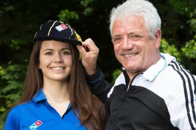 Former England football player and manager Kevin Keegan "caps" new employee Eva Juhasz, as she joins the Domino's team, which marks the pizza chain's creation of 10,000 new jobs to deal with demand from football fans during UEFA Euro 2016. Picture by: Jon Super/PA Wire