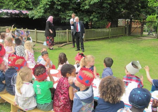 Kelvin Hopkins MP and Grasmere Nursery School pupils enjoy the Queen's 90th Birthday Street Party in the school's orchard