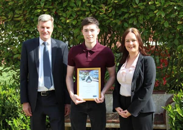 Luton teenager Andrew McCready (centre) receives his endowment