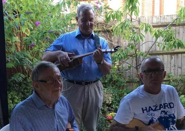 A trio from Ukie Toones entertained guests at an MND barbecue before presenting the charity with a cheque for Â£1,550