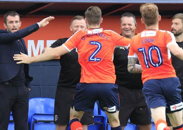 Stephen O'Donnell celebrates with Hatters kit man Darren Cook