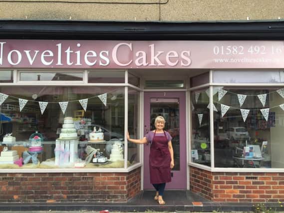 Sarah outside her shop, Novelties Cakes, in Luton
