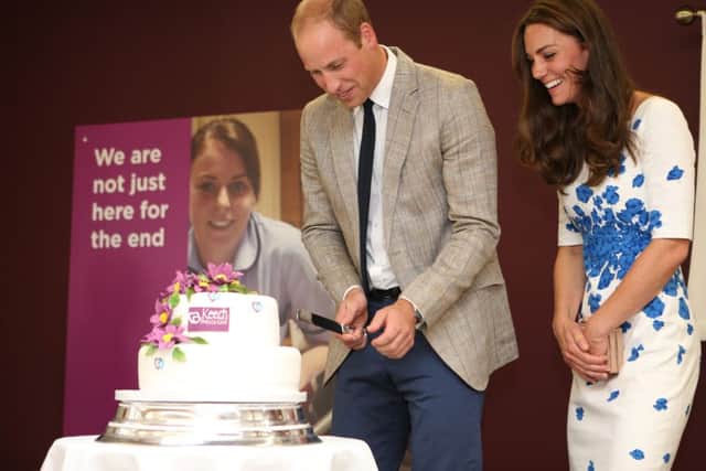 TRH The Duke and Duchess of Cambridge cut a cake at Keech Hospice Care. Photo by Danny Loo