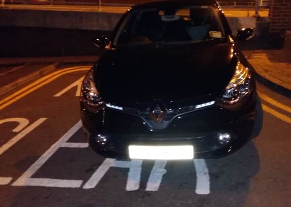 Parking enforcement officer parks on double yellow lines and a Keep Clear bay