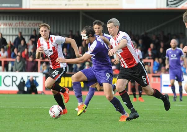 Danny Hylton tries to get away from the Cheltenham defence