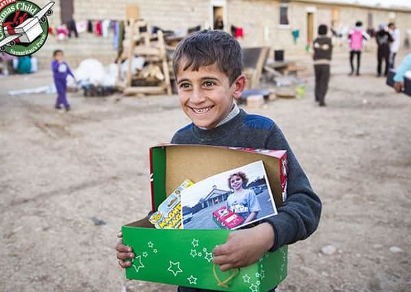 Six-year-old Bassam from northern Iraq is full of joy after receiving a gift-filled shoebox from Operation Christmas Child