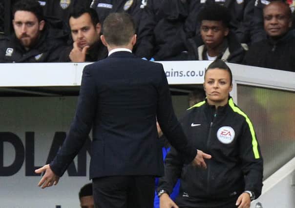 Town boss Nathan Jones questions referee Michael Salisbury's decisions to the fourth official