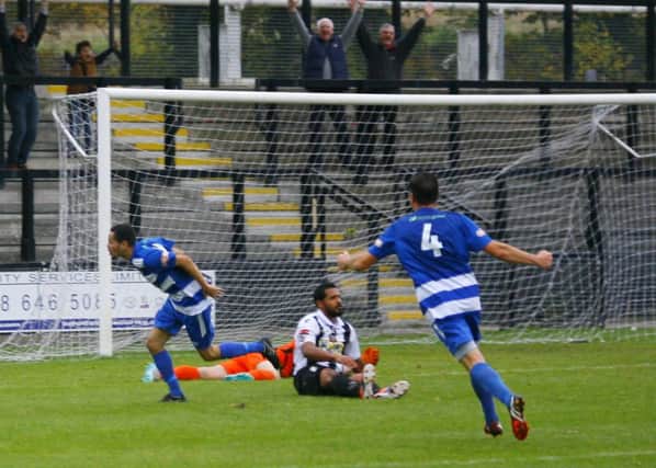 Saul Williams celebrates scoring Dunstable's fourth goal at Tooting