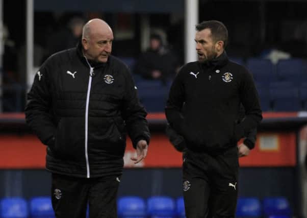 Hatters boss Nathan Jones discusses the first half with assistant Paul Hart