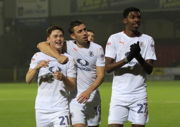 Jack Senior, Olly Lee and Tyreeq Bakinson celebrate Luton's 3-2 win at Swindon Town
