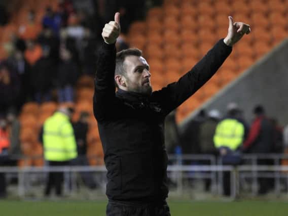 Hatters boss Nathan Jones salutes the travelling fans at Blackpool