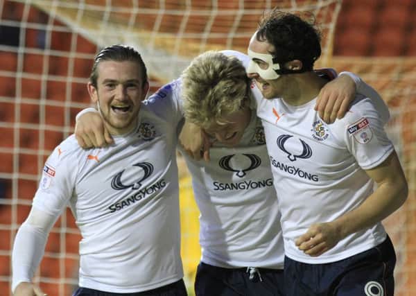 Cameron McGeehan celebrates making it 2-0 with Jack Marriott and Danny Hylton