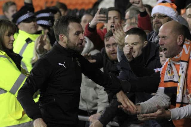 Luton boss Nathan Jones celebrates with the away supporters