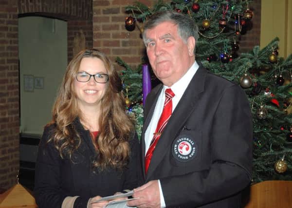 Vauxhall Male Voice Choir chairman Stuart Williams presents a cheque for Â£1,000 to Level Trust director Jane Malcolm after a charity Christmas concert
