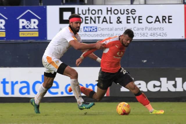 Isaac Vassell is brought down by Leon Legge for Luton's penalty