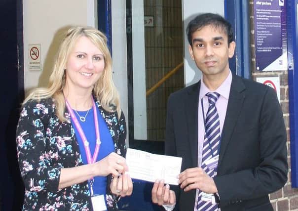Caron Hooper of Keech Hospice Care receives a cheque from Luton station manager Harsitt Chandak on behalf of Thameslink and Great Northern Railways